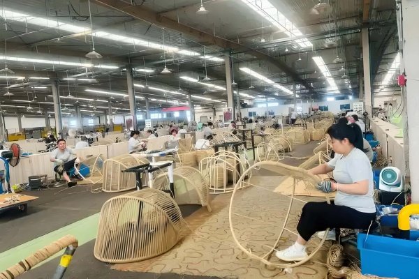 Skilled worker meticulously weaving a piece of wicker furniture Artisan Hand-Weaving Wicker Furniture