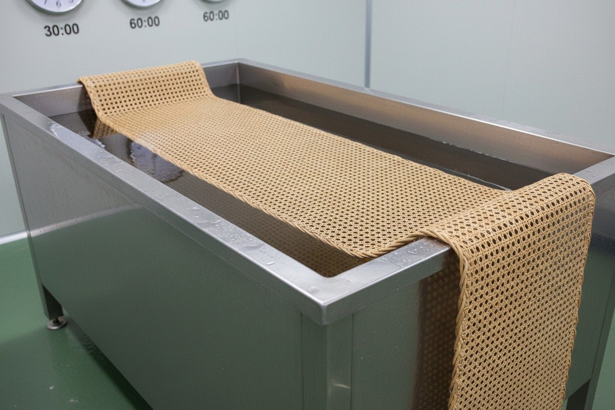 Soaking natural rattan cane webbing in warm water to ensure it dries tight and flat (ID#2)