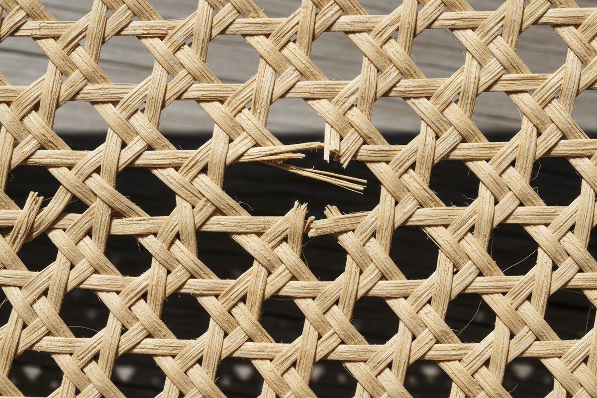 Sun damaged rattan webbing Brittle and faded natural rattan webbing showing signs of UV ray fiber damage (ID#3)